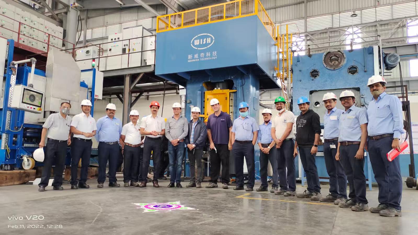 Industrial company team members at a manufacturing exhibition and facility