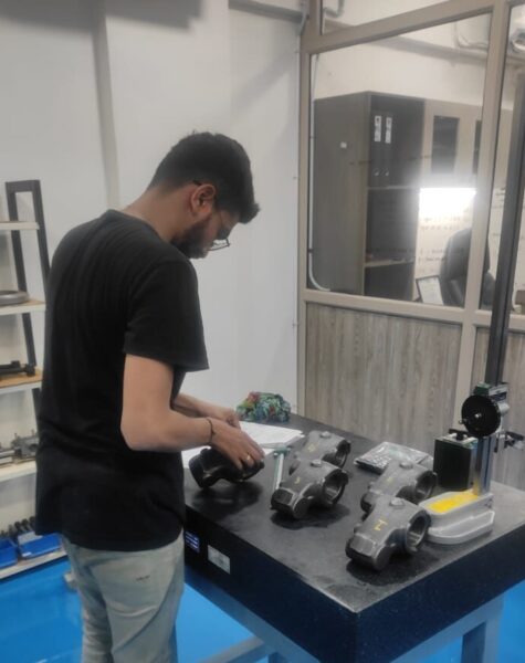 Worker inspecting industrial equipment during the sourcing process