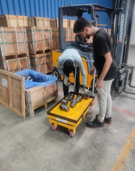 Worker handling industrial materials with equipment in a manufacturing facility